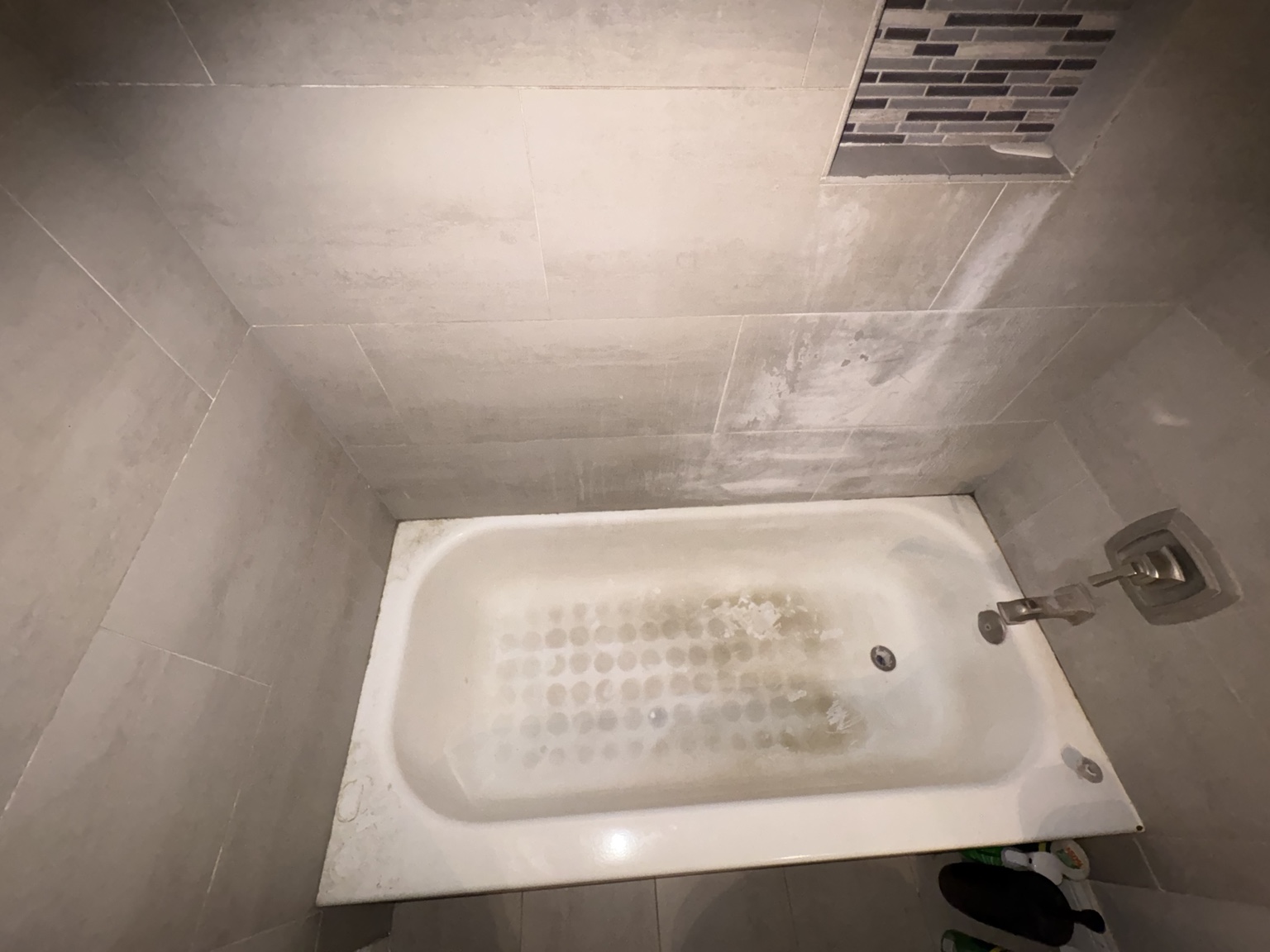 Stone tile bathtub before cleaning